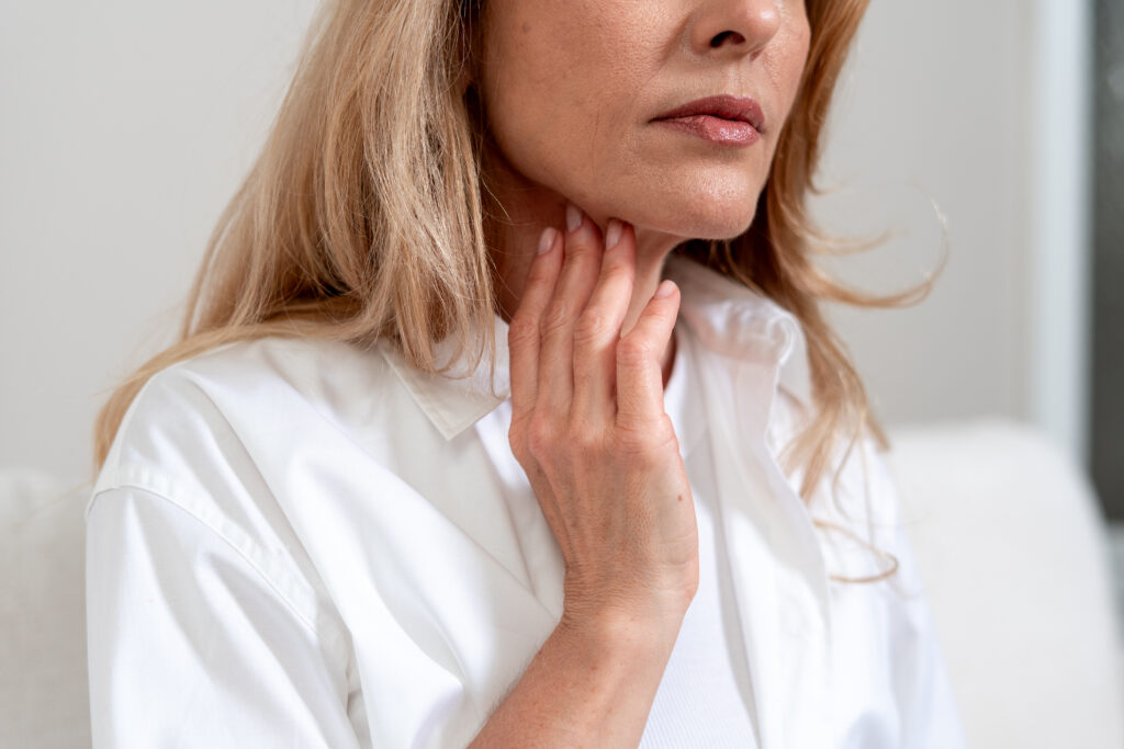 woman touching throat