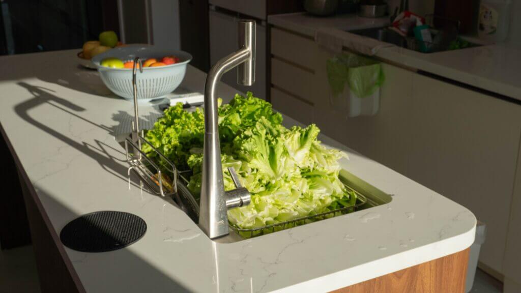 How to wash produce during a cyclospora outbreak by rinsing fresh vegetables under running water.